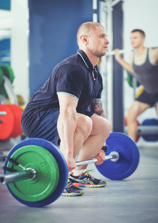 Bodybuilder with barbell in gym. Bodybuilderの写真素材