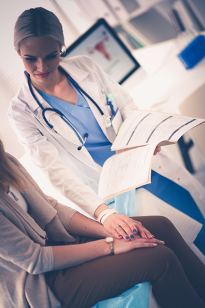 Doctor and patient discussing something while sitting at the table . Medicine and health care concept. Doctor and patientの写真素材
