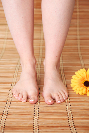 Care for beautiful woman legs with flower . Beautiful woman legsの写真素材
