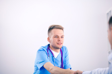 Male doctor standing with folder, isolated on white background. Male doctorの写真素材