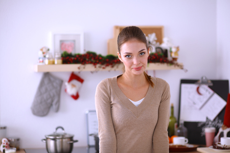 Smiling attractive woman having breakfast in kitchen interior. Smiling attractive woman.の写真素材