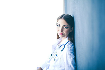 Doctor woman with stethoscope isolated on grey backgroundの写真素材