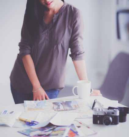 Female photographer sitting on the desk with laptopの写真素材