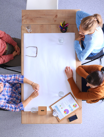 Business people sitting and discussing at meeting, in officeの写真素材