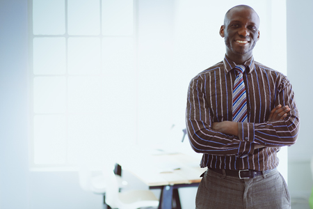 Portrait of an handsome black businessman standing in officeの写真素材