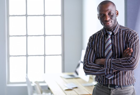 Portrait of an handsome black businessman standing in officeの写真素材