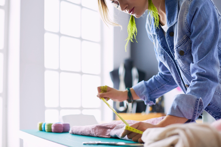 Fashion designer woman working on her designs in the studioの写真素材