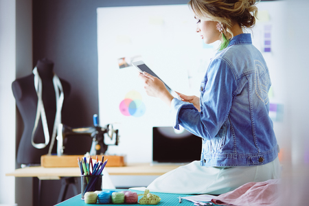 Fashion designer woman working on her designs in the studioの写真素材
