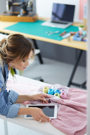 Fashion designer woman working on her designs in the studioの写真素材