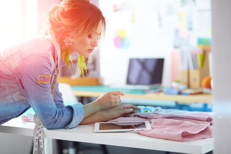 Fashion designer woman working on her designs in the studioの写真素材