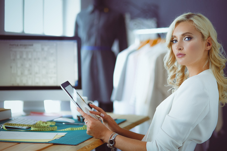 Fashion designer woman working on her designs in the studioの写真素材