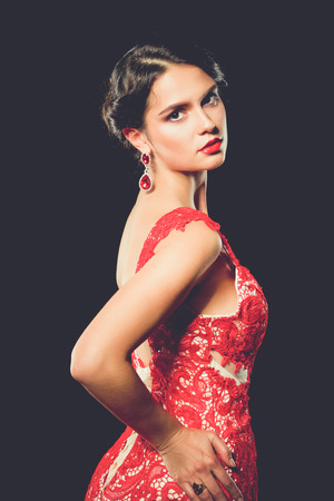 Pretty young model female with dark hair in amazing long red dressの写真素材