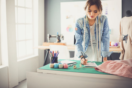 Fashion designer woman working on her designs in the studio