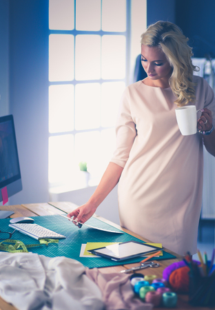 Fashion designer woman working on her designs in the studioの写真素材