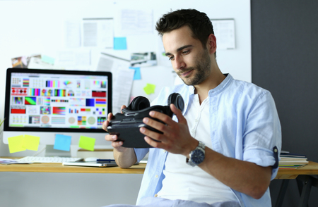 Young male software programmer testing a new app with 3d virtual reality glasses in officeの写真素材