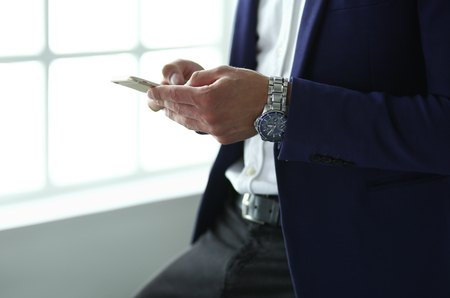 young businessman writing sms in his office.の写真素材