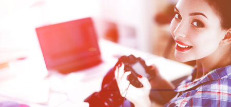 Female photographer sitting on the desk with laptop