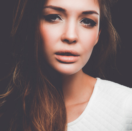 Portrait of a beautiful woman , isolated on black backgroundの写真素材