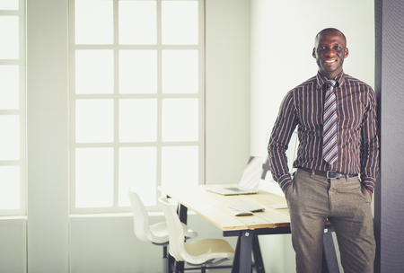 Portrait of an handsome black businessman standing in officeの写真素材