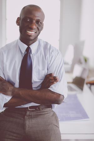Portrait of an handsome black businessman standing in officeの写真素材