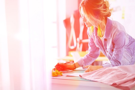 Fashion designer woman working on her designs in the studioの写真素材