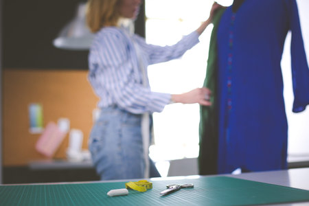 Fashion designer working on her designs in the studio