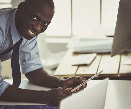 Portrait of an handsome black businessman standing in officeの写真素材