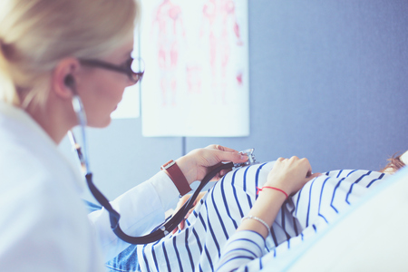 Doctor and patient discussing something while sitting at the table . Medicine and health care conceptの写真素材