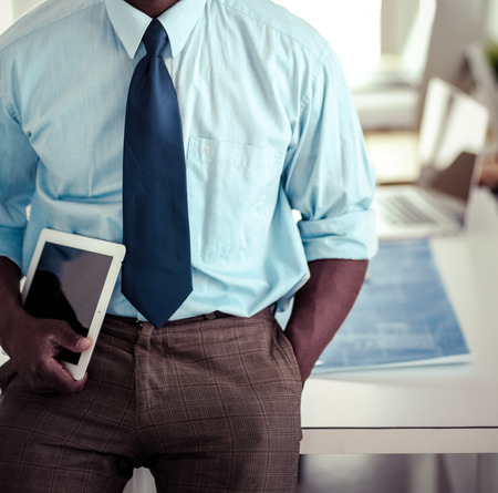 Portrait of an handsome black businessman standing in officeの写真素材