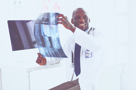 Portrait young african medical doctor holding patients x-rayの写真素材