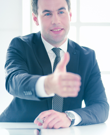 Portrait of businessman giving hand for handshake.の写真素材