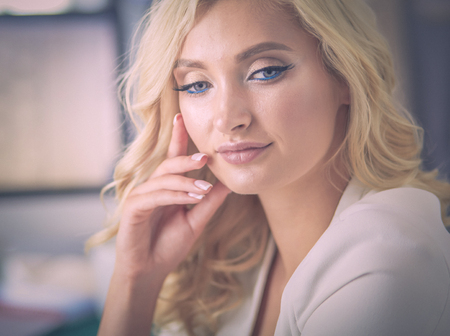 Beautiful young woman portrait , sitting in office.の写真素材