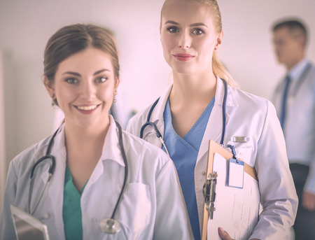 Woman doctor standing with folder at hospitalの写真素材