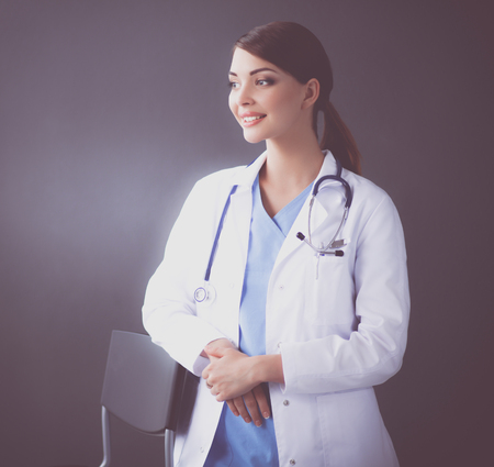 Doctor woman with stethoscope isolated on grey backgroundの写真素材