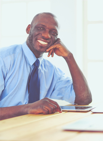 African american businessman on headset working on his laptopの写真素材