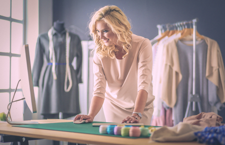Fashion designer woman working on her designs in the studio.の写真素材