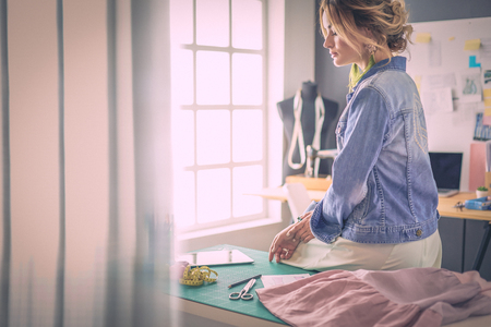 Fashion designer woman working on her designs in the studioの写真素材