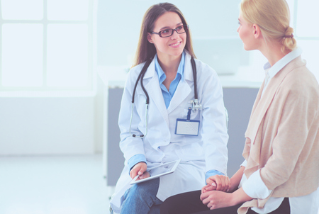 Doctor and patient discussing something while sitting at the table . Medicine and health care conceptの写真素材
