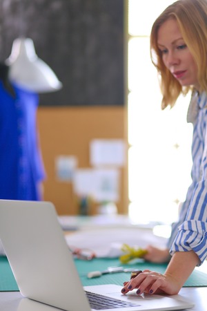 Fashion designer working on her designs in the studioの写真素材