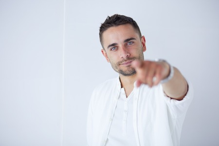 Young business man standing isolated on white background.の写真素材