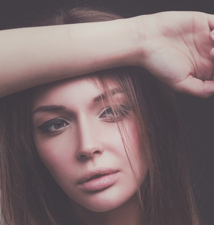 Beauty. Portrait of a young woman on dark backgroundの写真素材