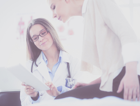 Doctor and patient discussing something while sitting at the table . Medicine and health care conceptの写真素材