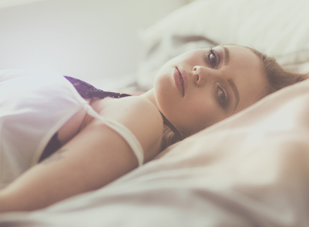 Sexy fashionable woman on the bedの写真素材