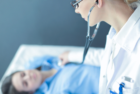 Doctor and patient discussing something while sitting at the table . Medicine and health care conceptの写真素材