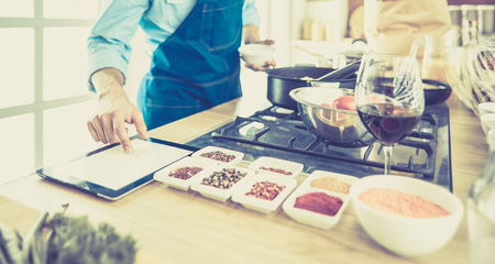 Man preparing delicious and healthy food in the home kitchenの写真素材