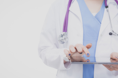 Female doctor using a digital tablet and standing on white background. Woman doctors.の写真素材