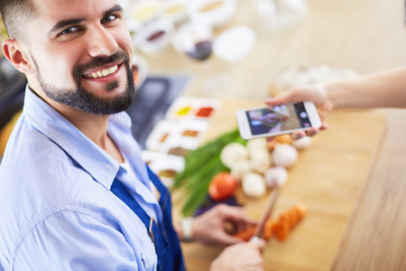 Man preparing delicious and healthy food in the home kitchenの写真素材