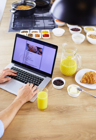 Man preparing delicious and healthy food in the home kitchenの写真素材