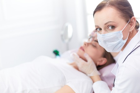 A young girl having red lips permanent makeup, micropigmentationの写真素材