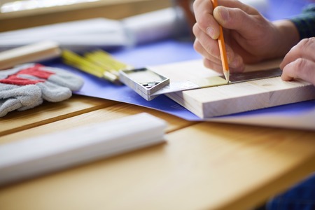 Architect working on drawing table in officeの写真素材